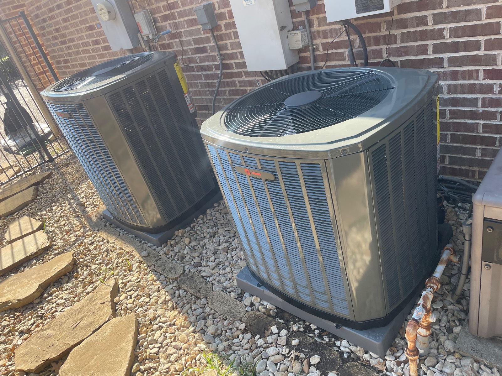 Pair of new Trane outdoor condensers on pads